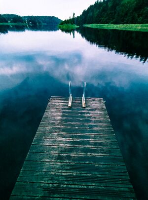 Picture of a jetty on a calm lake at night